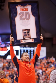 Brandon Triche, hoists his senior jersey into the air during a ceremony for Senior Night.