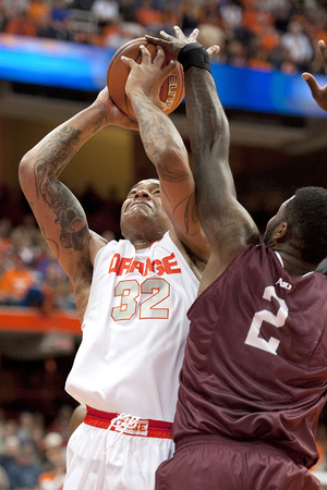 DaJuan Coleman struggles to shoot over Fordham big man Travion Leonard in SU's 89-74 win against the Rams on Tuesday.