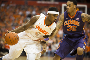 C.J. Fair drives past Clemson forward K.J. McDaniels in the No. 1 Orange's 57-44 win in the Carrier Dome on Sunday. 