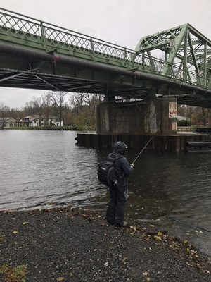 Patrick Durand, vice president of the team, casts a line on the shores of Onondaga lake.