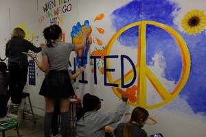 Students and professors of the School of Art paint a mural over the racial-bias graffiti that was reported on Tuesday morning.