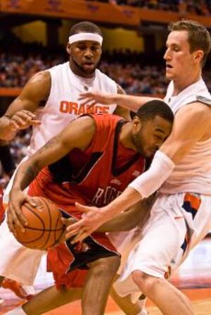 Arizne Onuaku and Kristof Ongenaet play defense against Rutgers' Anthony Farmer in Syracuse's 70-40 win over the Scarlet Knights Tuesday night at the Carrier Dome. The Orange was down one at halftime before surging in the second half to outscore RU 51-20.  