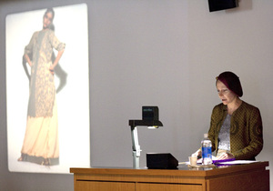 mary mcfadden, a fashion designer, presents her collection to students during her lecture at the Warehouse Auditorium on Tuesday. McFadden showed how her designs were influenced by Ancient Mesopotamia, Egypt, Zimbabwe, Renaissance Europe and China.