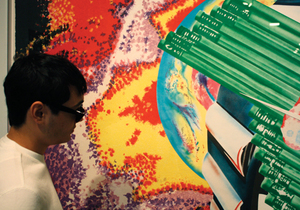 Chris Torres, a freshman pre-med student, admires a piece in SUArt gallery's latest exhibit '4x4'.