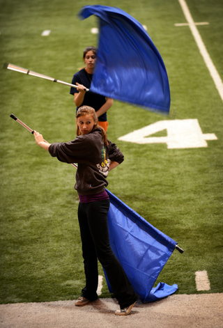 Natasha Olejar, an SU junior, waits for a signal from her instructor during a color guard practice.