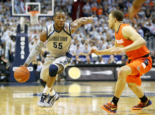 Jabril Trawick (55) drives to the basket against Brandon Triche.