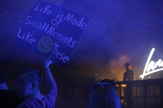 Nikita Albert, a sophomore engineering major, holds a sign in the front row at the F-Shed on Wednesday night. 