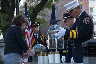 Miner lights six candles in two glass containers at 8:46 a.m., the time American Airlines Flight 11 hit the north tower.