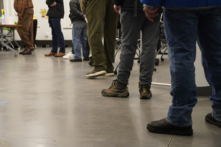 After the ballot printer at Huntington Hall stopped working when the polls opened, the line quickly grew with anticipatory voters.