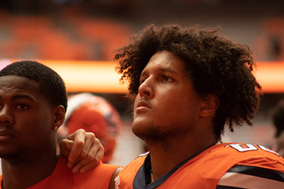 Matthew Bergeron stands next to the rest of the team as SU’s marching band sings the Alma Mater. The Orange have maintained this tradition after each home game despite the outcome. 