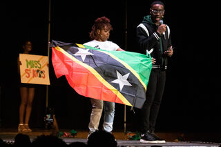 Tarena Woodley represents St. Kitts in the Caribfest pageant. Throughout the contest, Woodley performed a skit, made food for the judges and advocated for the importance of female independence and the privatization of water.